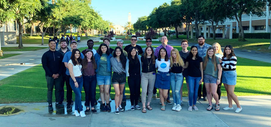 A group of students pictured outside on a college campus